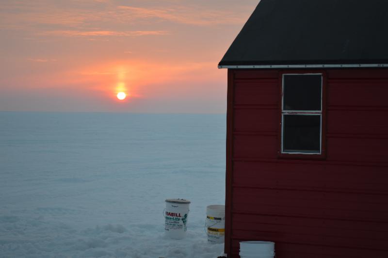 Ice fishing, sunset, Arnesen's fish house.